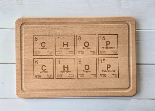 Wooden cutting board with engraved chemical formula on a light wooden surface